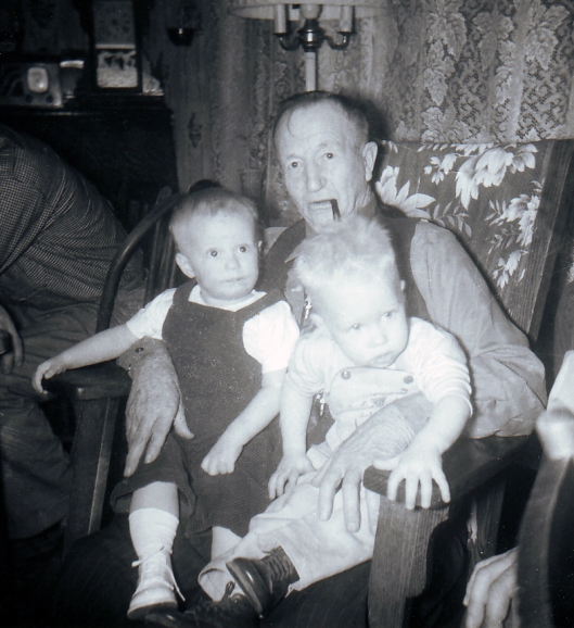 Grandpa John with me (on left knee) and Tom (on right knee)